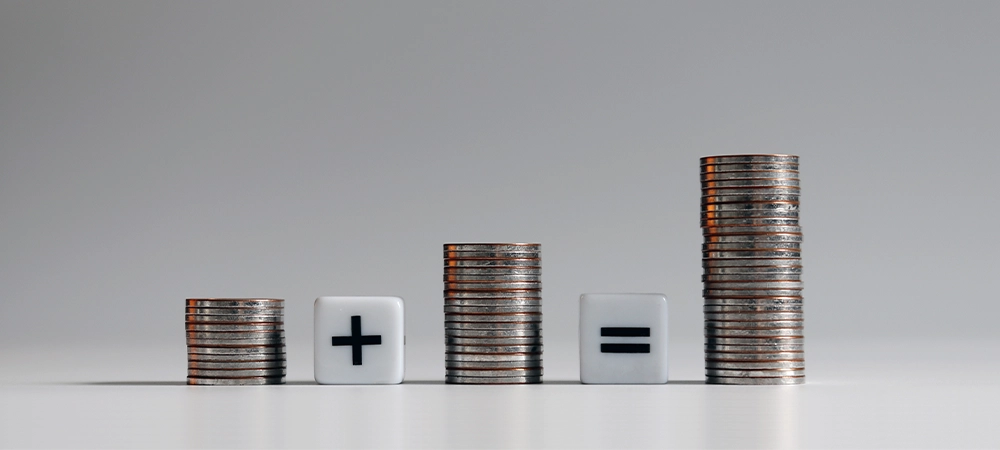 Three pile of coins with mathematical arithmetic symbols.